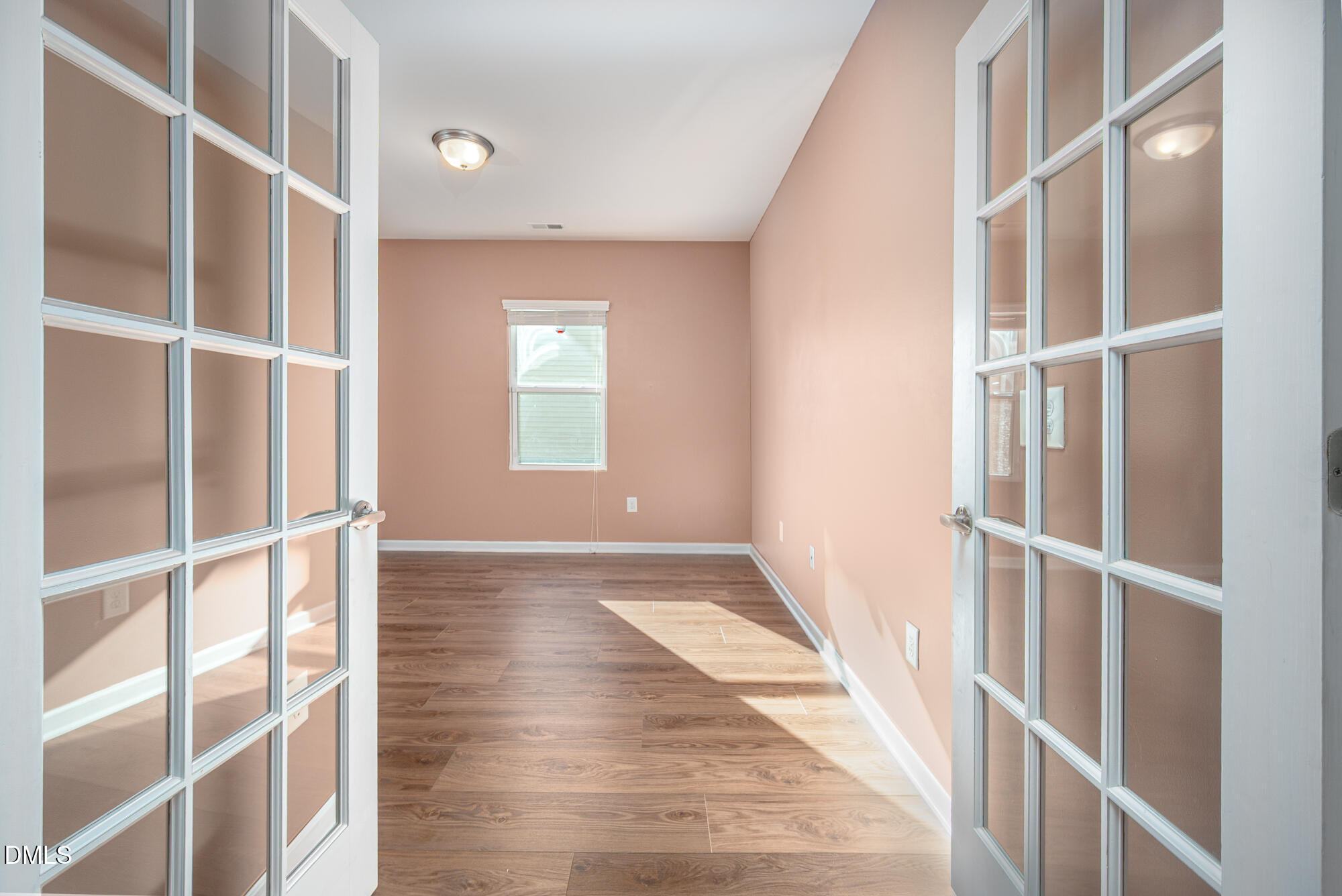 3548 Althorp Drive Raleigh, NC 27616 - Photo 8 of 56 a view of an empty room with wooden floor and a window