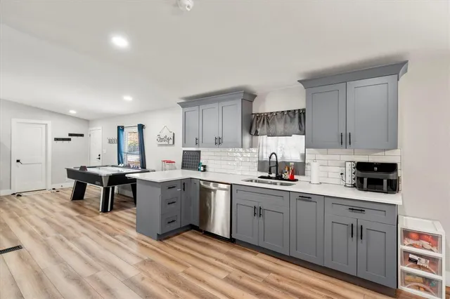 a kitchen with a sink stove and cabinets