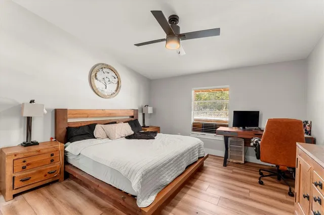 a bedroom with a bed and a desk