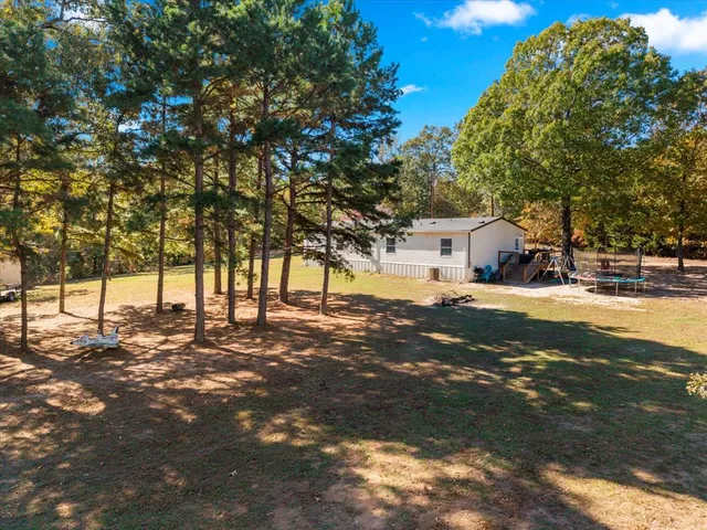 a view of road with large trees