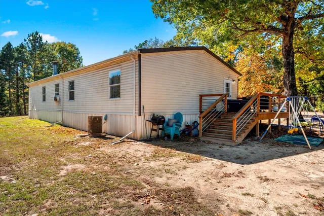 a backyard of a house with oven and a tree