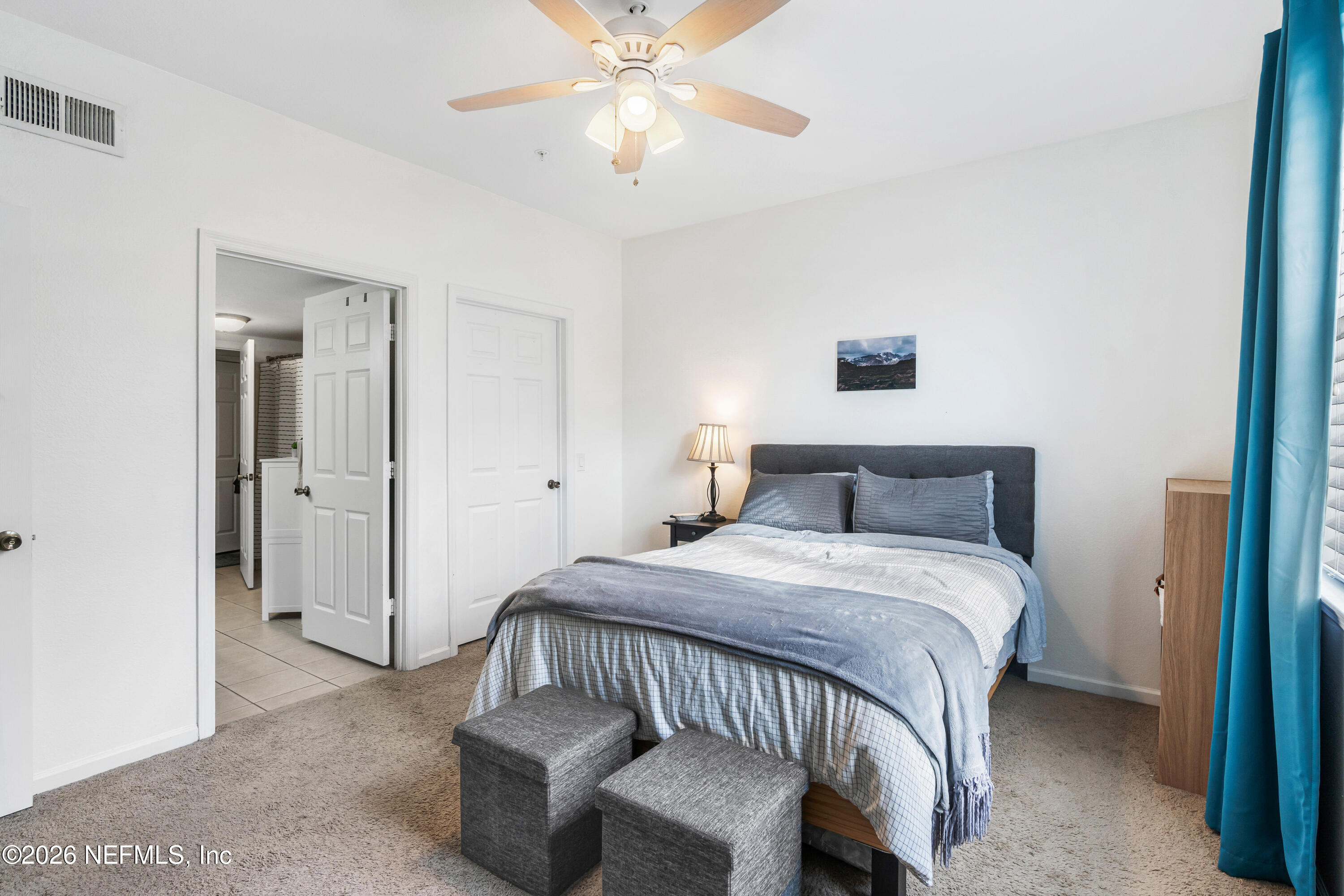 8550 Touchton Road, Unit 1034 Jacksonville, FL 32216 - Photo 12 of 30 a bedroom with a bed and a chandelier