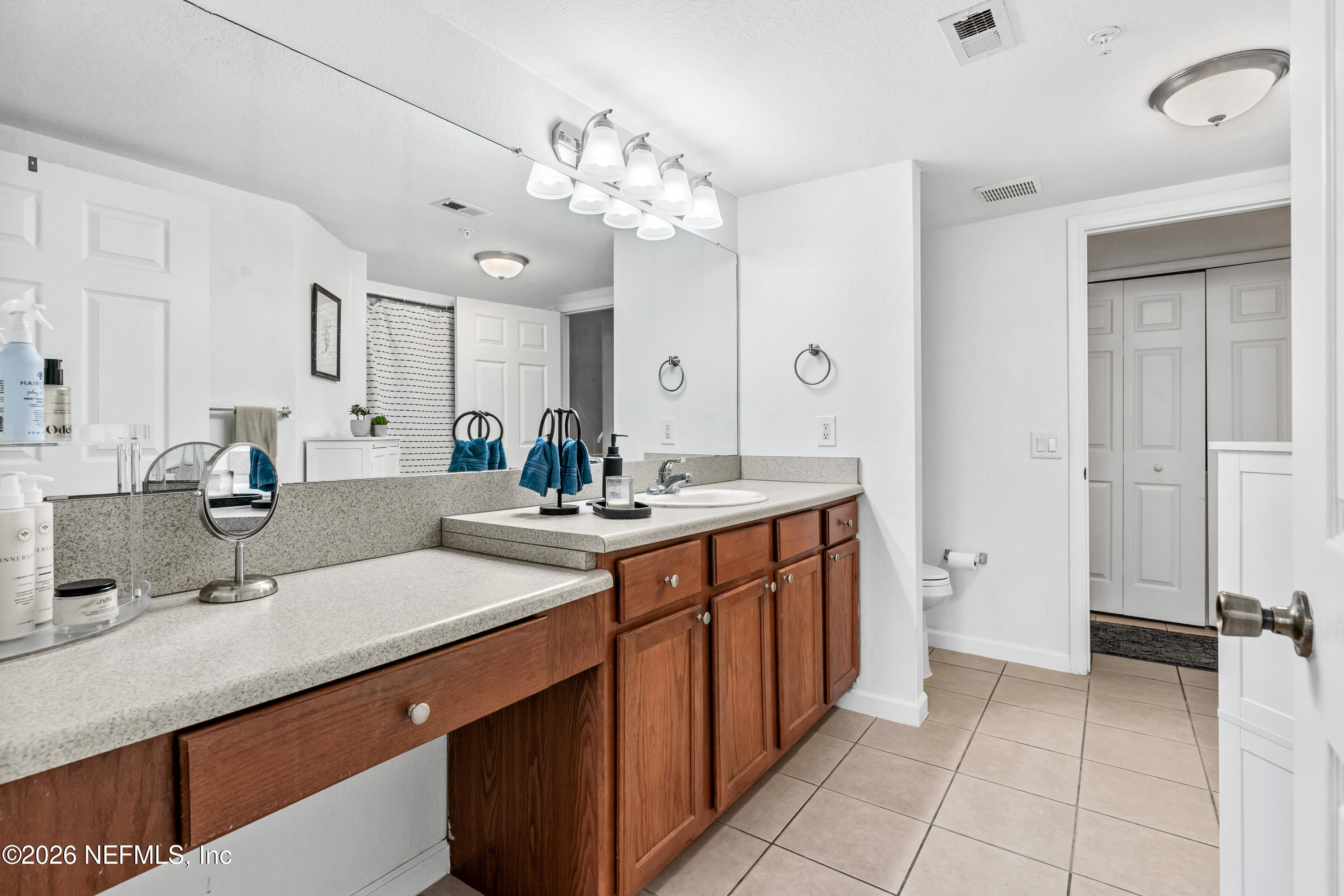 8550 Touchton Road, Unit 1034 Jacksonville, FL 32216 - Photo 15 of 30 a spacious bathroom with a double vanity sink mirror and