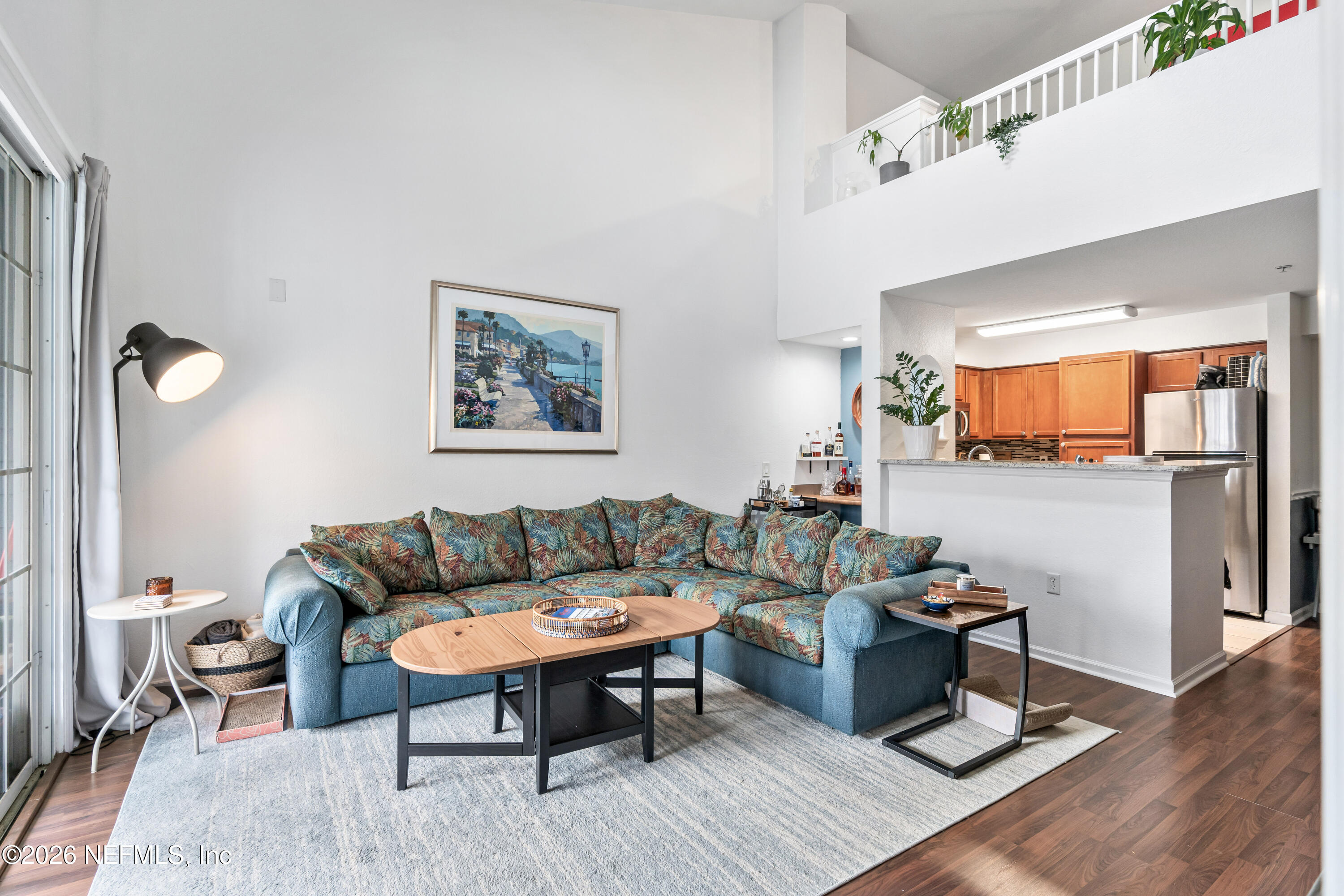 8550 Touchton Road, Unit 1034 Jacksonville, FL 32216 - Photo 17 of 30 a living room with furniture wooden floor and a table
