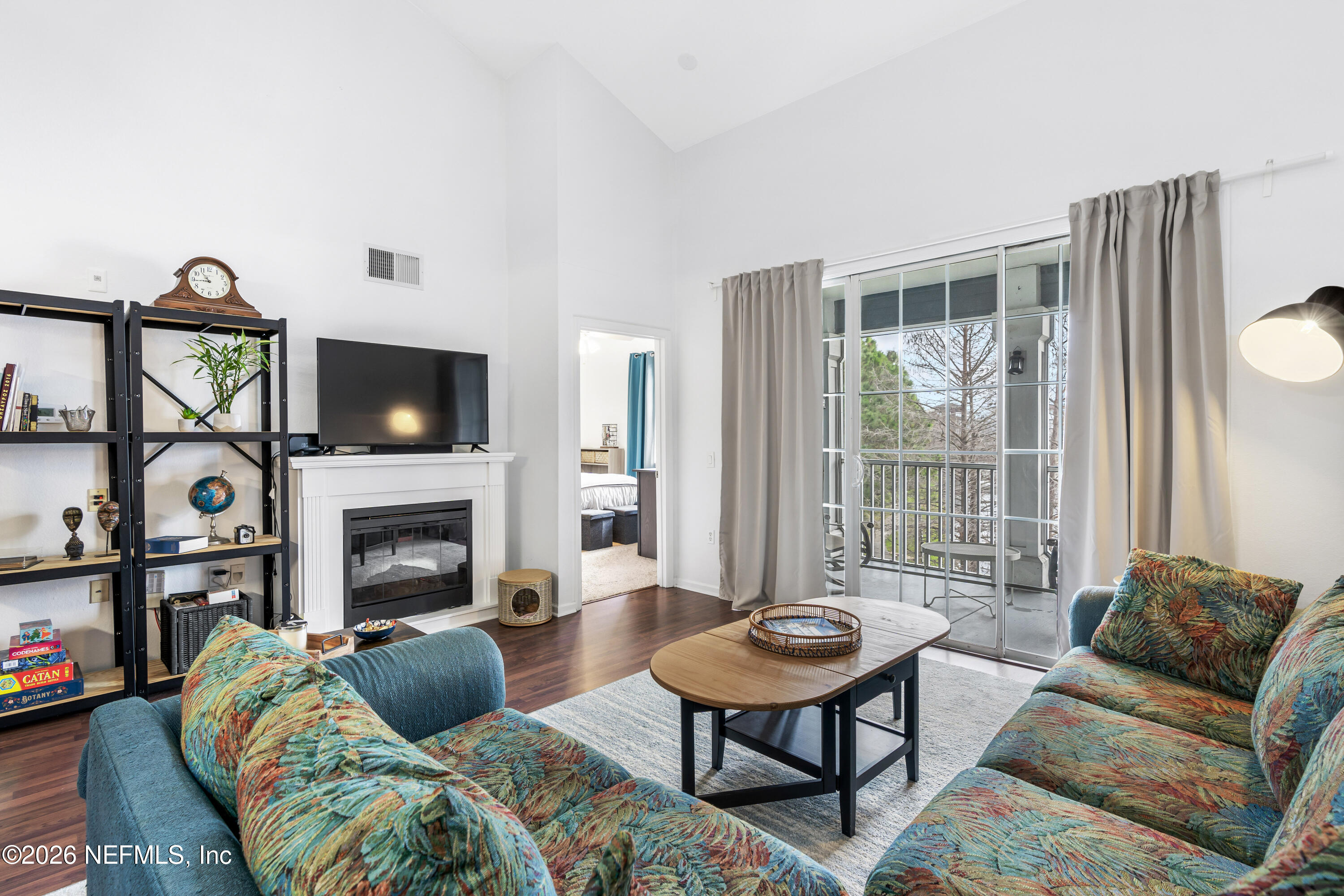 8550 Touchton Road, Unit 1034 Jacksonville, FL 32216 - Photo 19 of 30 a living room with furniture a flat screen tv and a fireplace