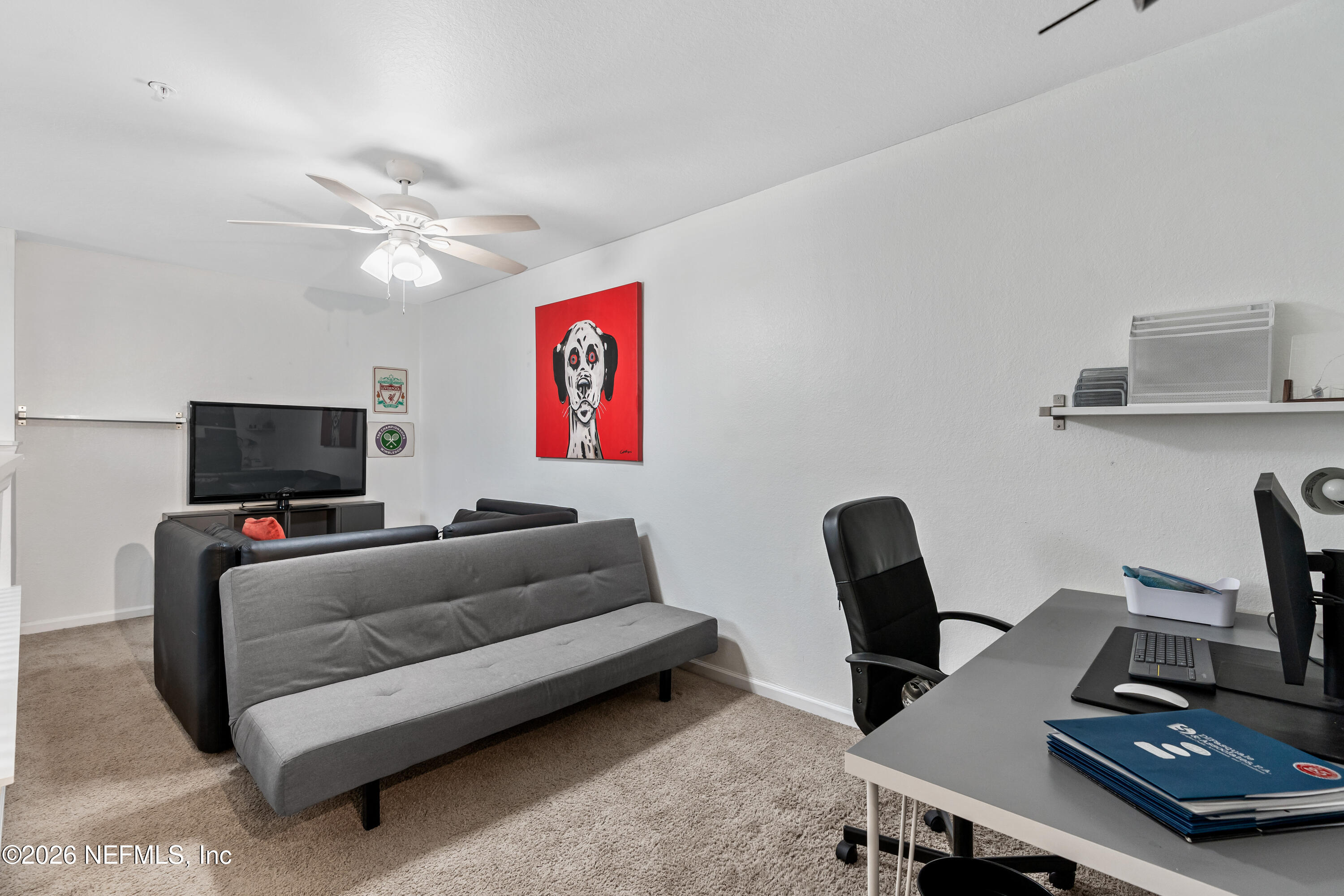 8550 Touchton Road, Unit 1034 Jacksonville, FL 32216 - Photo 21 of 30 a living room with furniture and a flat screen tv