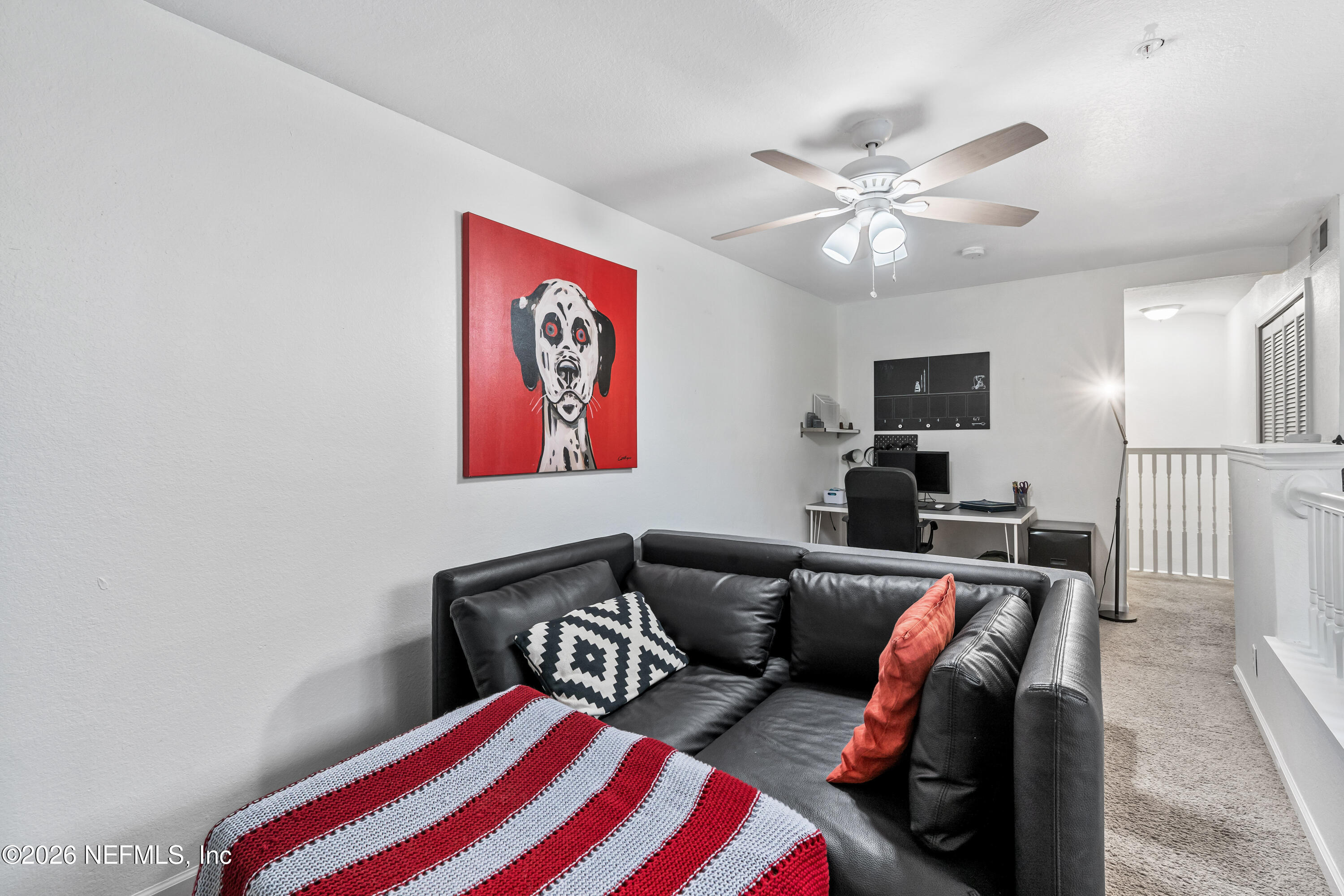 8550 Touchton Road, Unit 1034 Jacksonville, FL 32216 - Photo 22 of 30 a living room with furniture and a flat screen tv