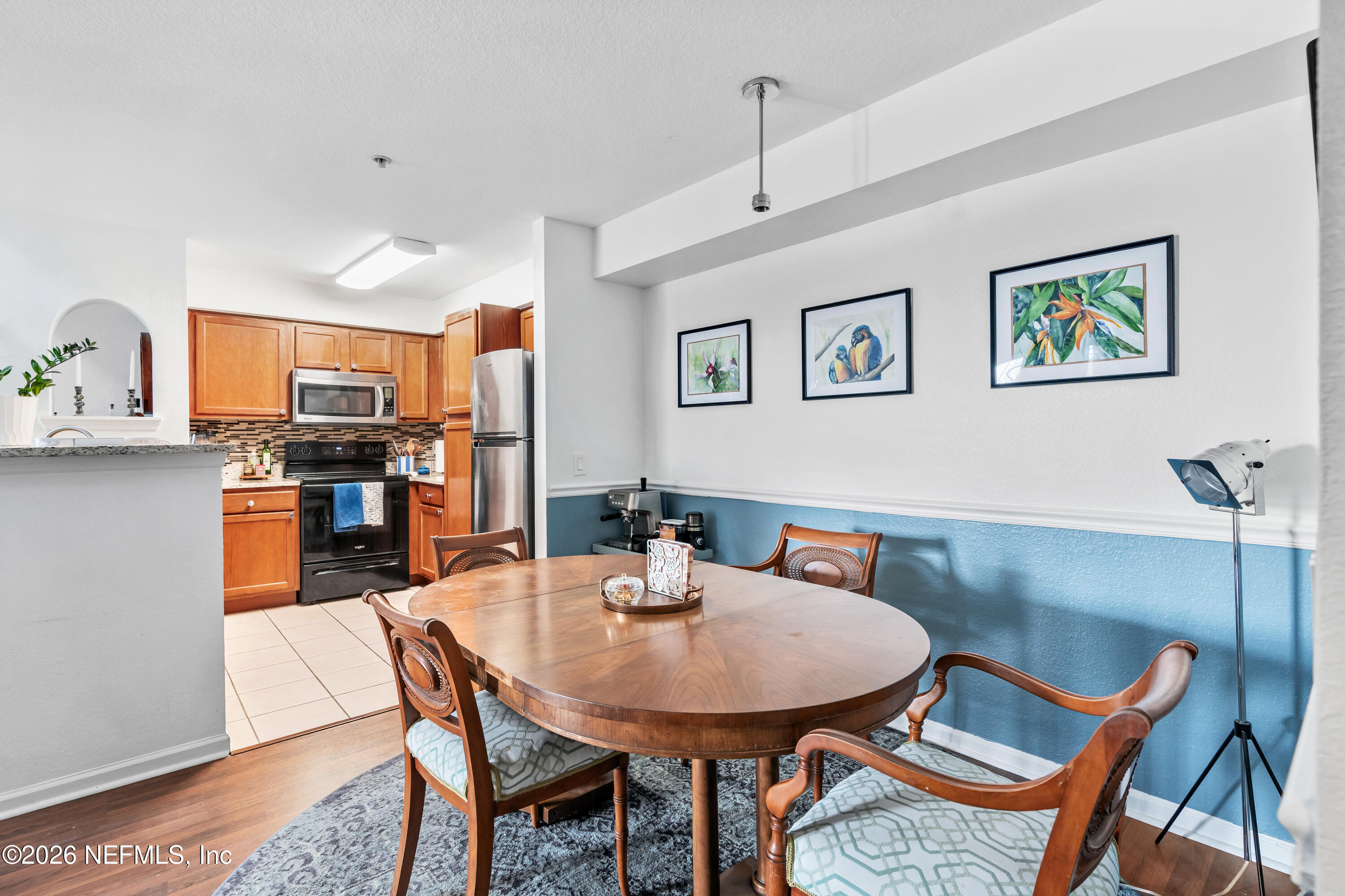 8550 Touchton Road, Unit 1034 Jacksonville, FL 32216 - Photo 6 of 30 a view of a dining room with furniture and wooden floor