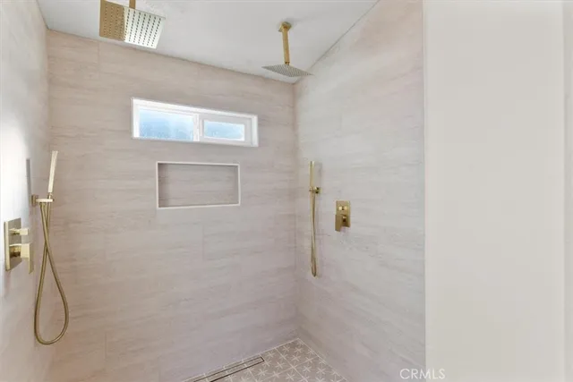 a view of empty room with wooden floor and window