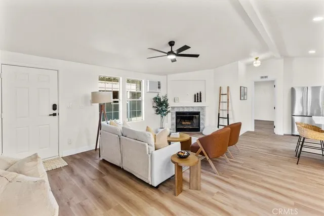 a view of a dining room and livingroom with furniture wooden floor a chandelier