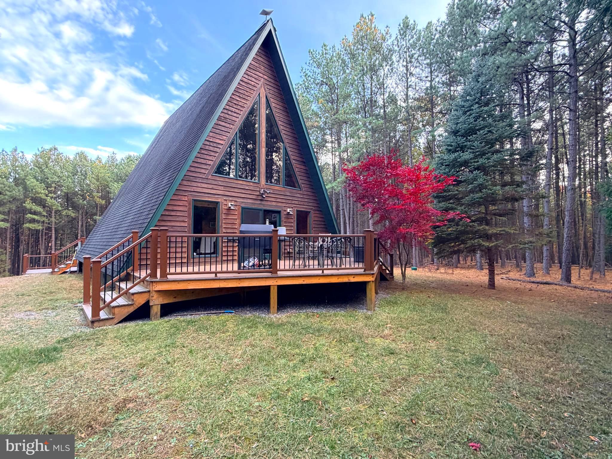4839 Graces Cabin Road Romney, WV 26757 - Photo 15 of 26 a backyard of a house with table and chairs