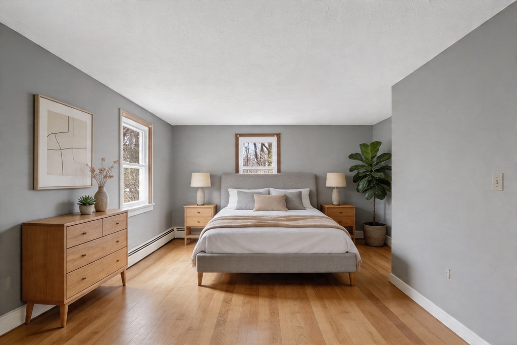 73 Nashua Road Pepperell, MA 01463 - Photo 18 of 33 a bedroom with a large bed and a potted plant