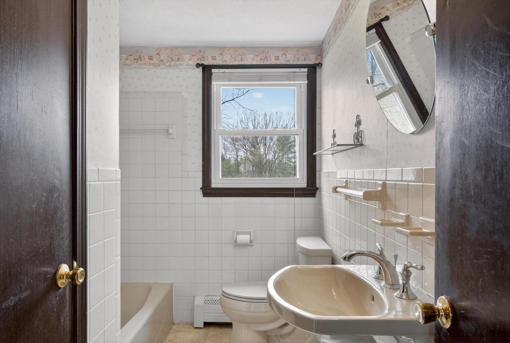 73 Nashua Road Pepperell, MA 01463 - Photo 21 of 33 a bathroom with a sink a mirror and a toilet