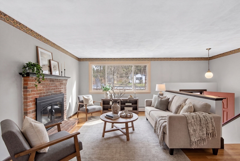 73 Nashua Road Pepperell, MA 01463 - Photo 6 of 33 a living room with furniture and a fireplace