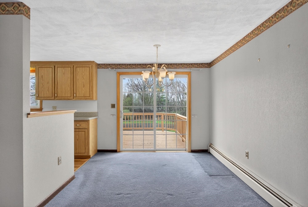 73 Nashua Road Pepperell, MA 01463 - Photo 8 of 33 a view of a kitchen with large windows