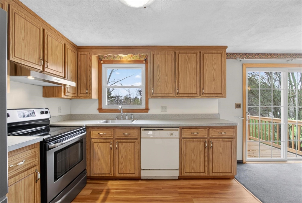 73 Nashua Road Pepperell, MA 01463 - Photo 10 of 33 a kitchen with stainless steel appliances granite countertop a stove a sink and a microwave