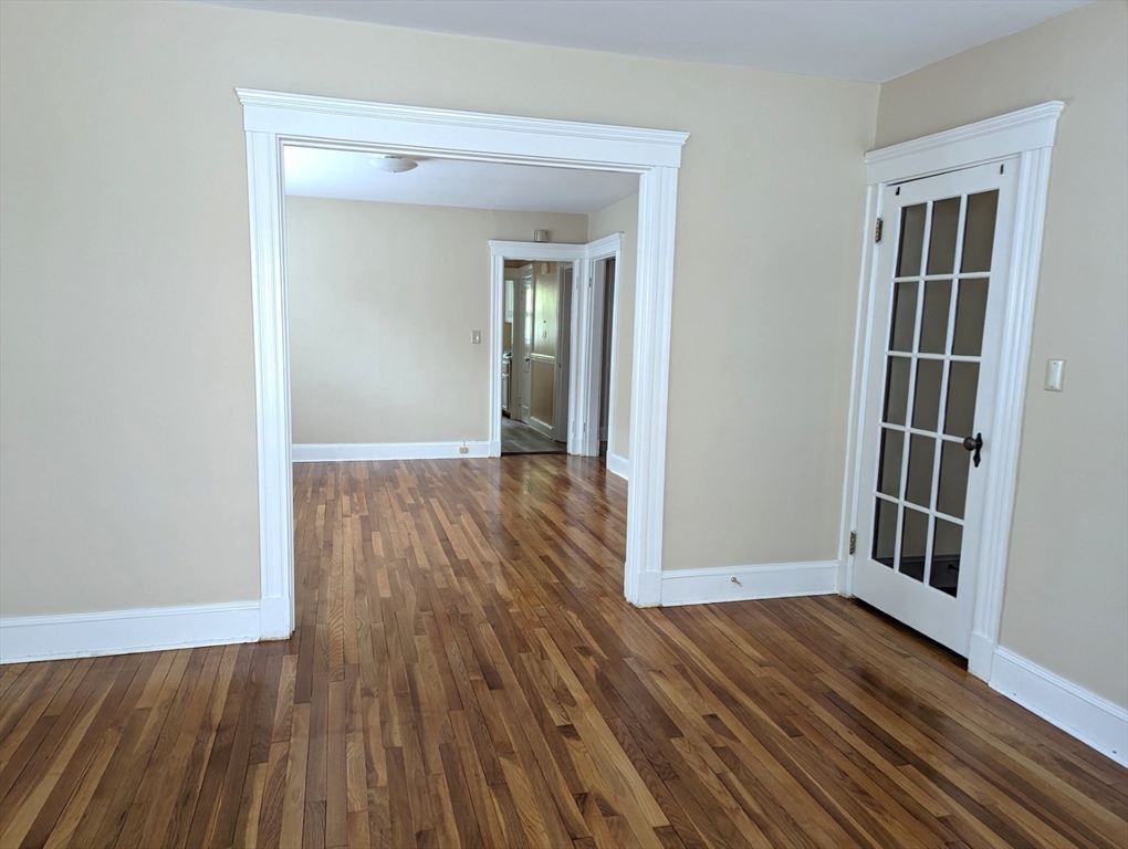 25 Glendower Road, Unit 2 Boston, MA 02131 - Photo 6 of 17 an empty room with wooden floor and a window