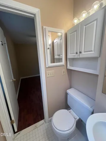 a white toilet sitting next to a bathroom sink