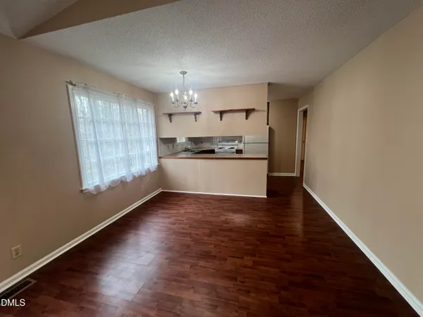 a view of a kitchen with a sink wooden floor and a window