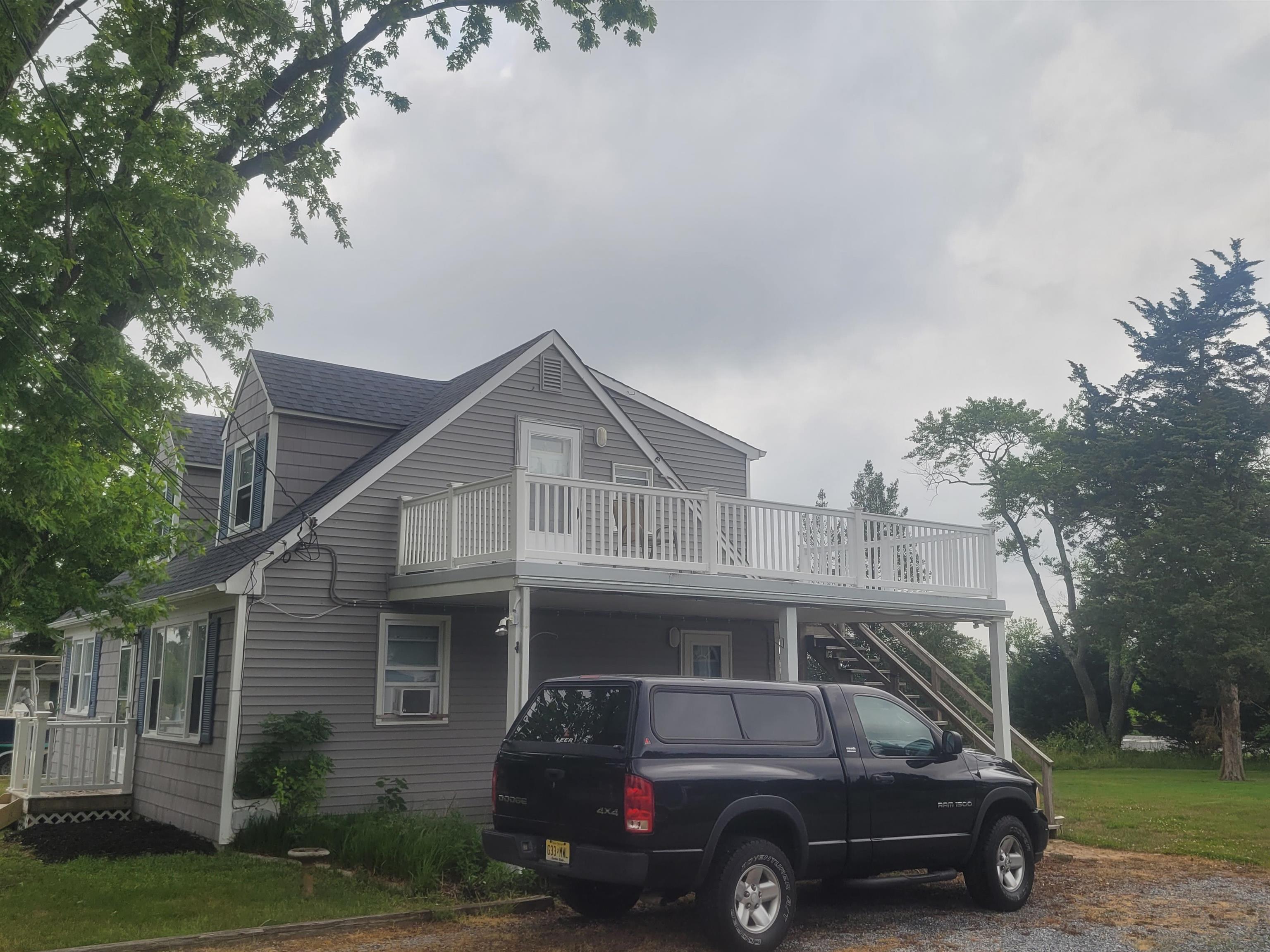 33 Stanhope Road Marmora, NJ 08223 - Photo 20 of 22 a car parked in front of a house