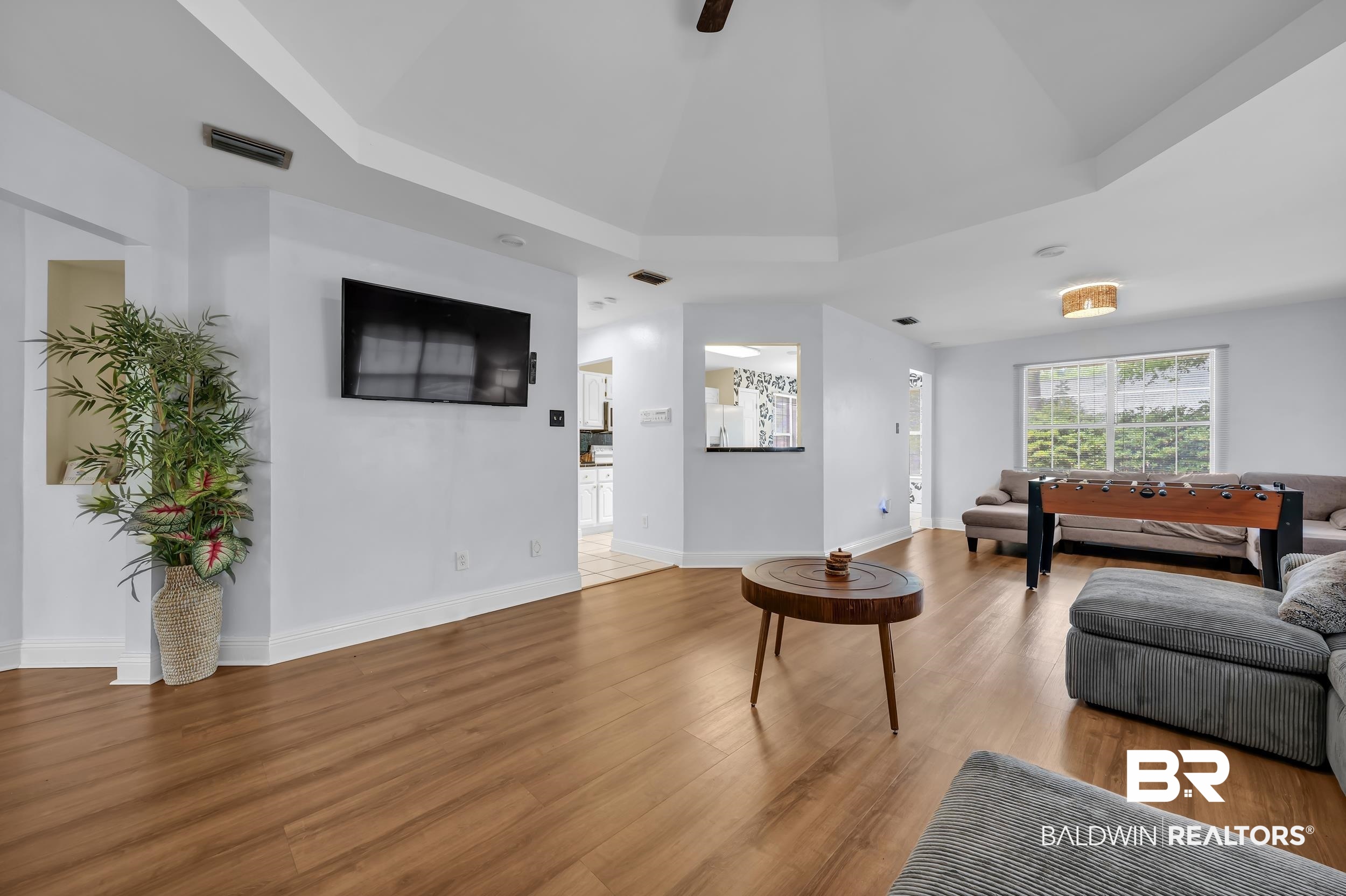 509 Loblolly Court Foley, AL 36535 - Photo 4 of 26 Spacious living area featuring wood-finish flooring, a tray ceiling, and a large window