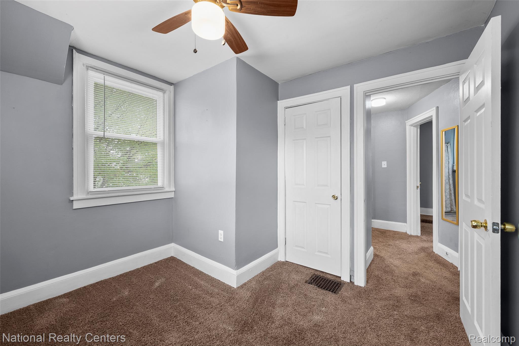 686 Perry Street Pontiac, MI 48342 - Photo 21 of 26 Unfurnished bedroom featuring dark colored carpet and a ceiling fan