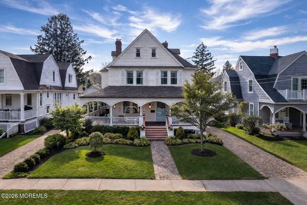 a front view of a house with a garden and plants