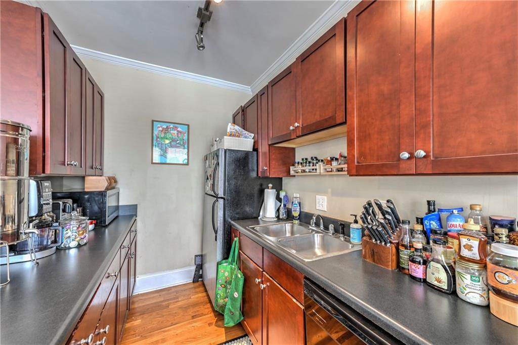 733 Frederica Street Northeast, Unit 2 Atlanta, GA 30306 - Photo 4 of 11 a kitchen with stainless steel appliances granite countertop a sink refrigerator and cabinets