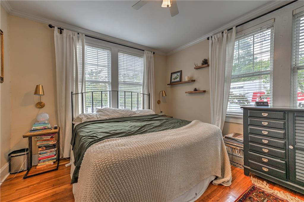 733 Frederica Street Northeast, Unit 2 Atlanta, GA 30306 - Photo 7 of 11 a bedroom with a bed and a dresser next to a window