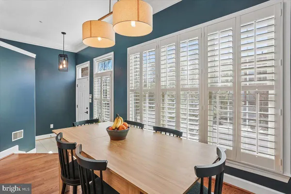 a view of a dining room with furniture and a large window