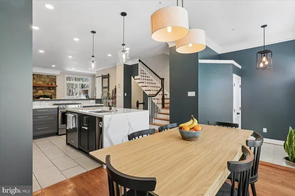 a large kitchen with a table and chairs