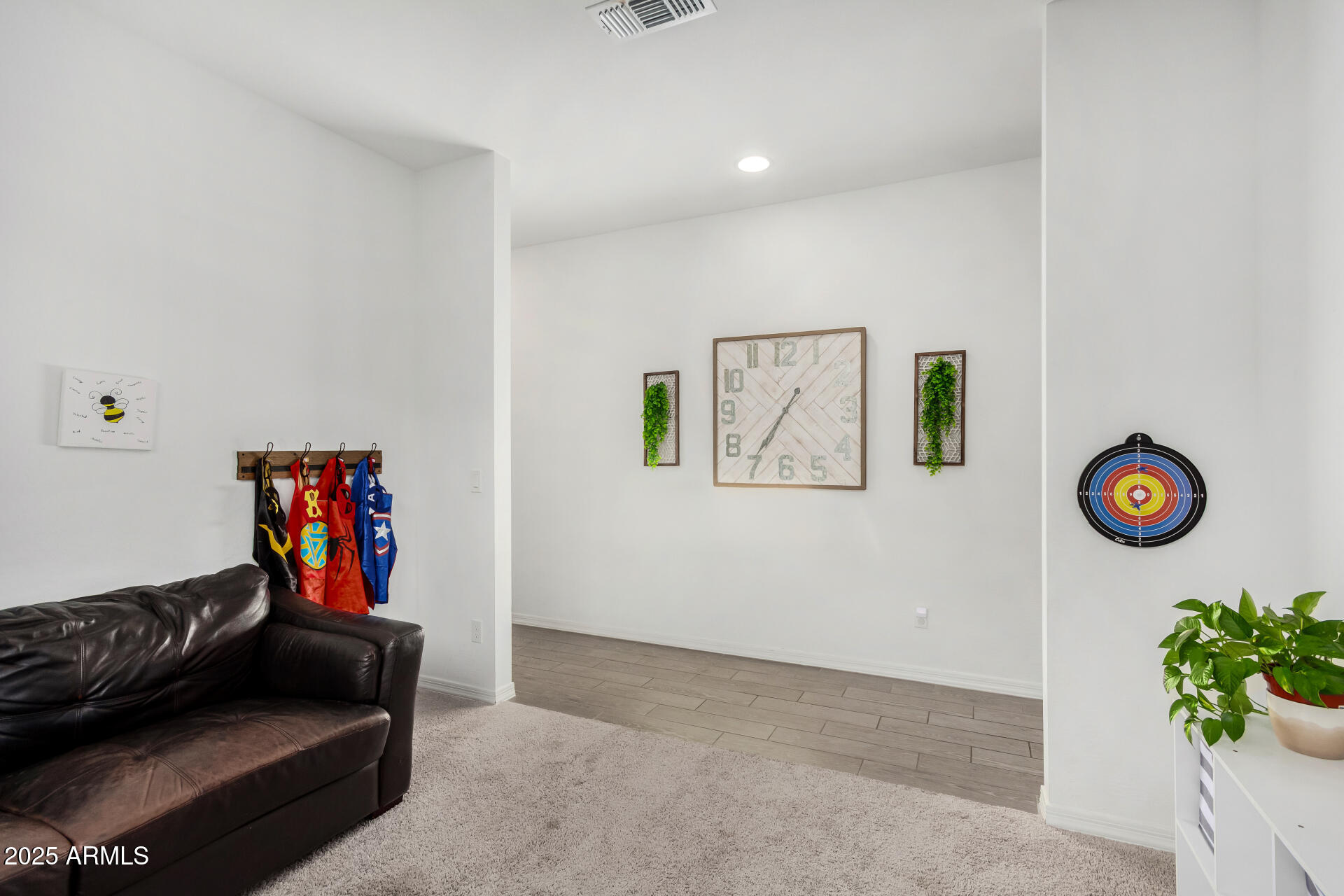 11517 East Unity Avenue Mesa, AZ 85212 - Photo 13 of 48 a living room with couch and paintings on the wall