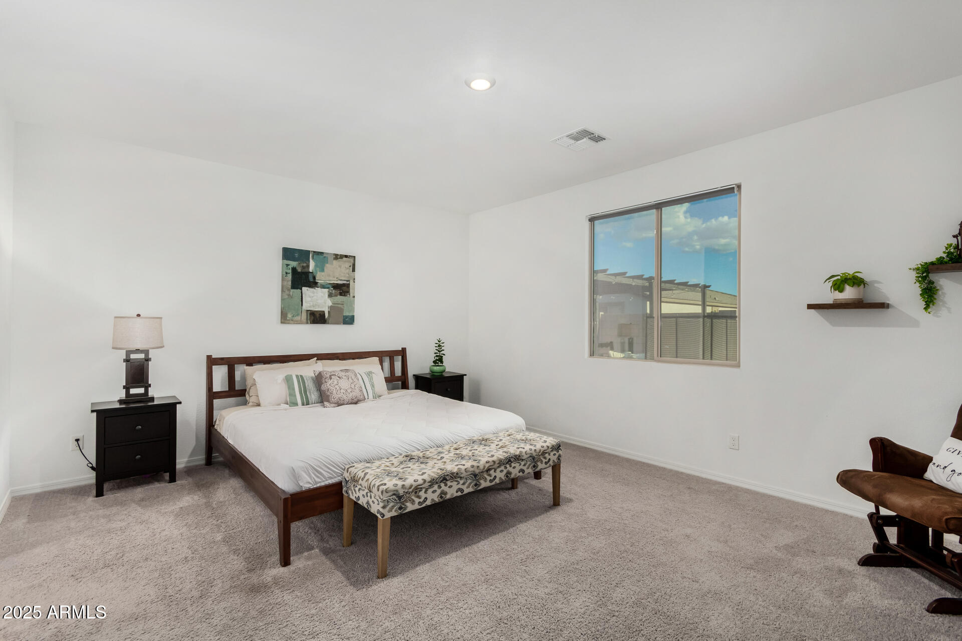11517 East Unity Avenue Mesa, AZ 85212 - Photo 14 of 48 a bedroom with a bed and a lamp on table