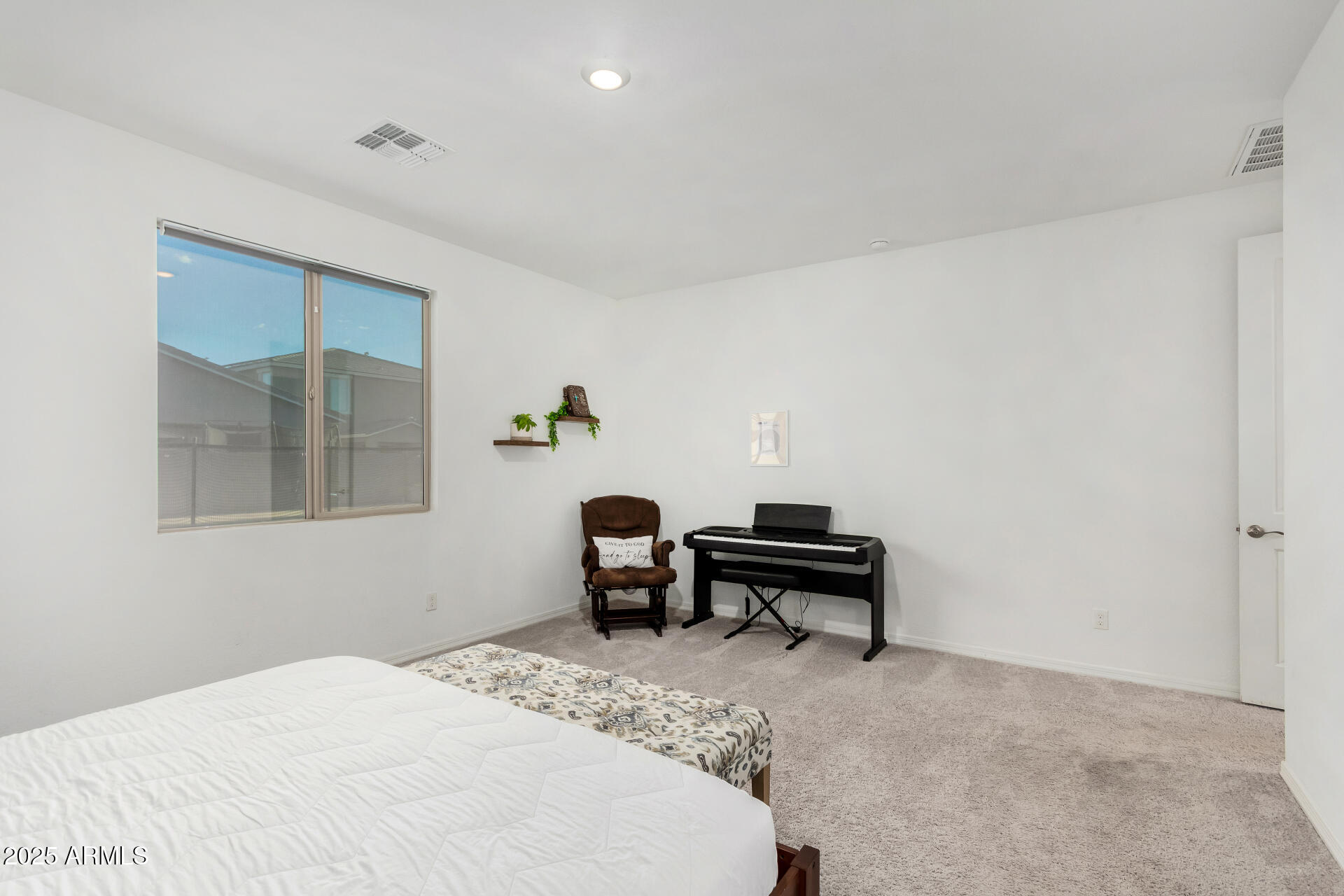 11517 East Unity Avenue Mesa, AZ 85212 - Photo 17 of 48 a bedroom with a bed and a window