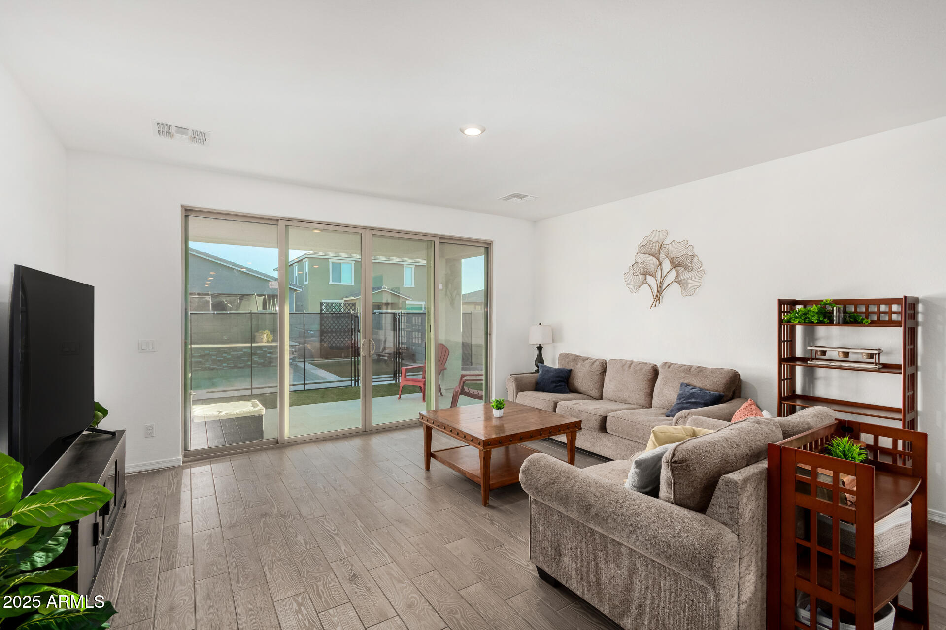 11517 East Unity Avenue Mesa, AZ 85212 - Photo 6 of 48 a living room with furniture and a flat screen tv
