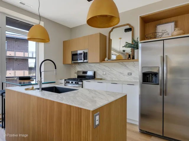 a kitchen with a refrigerator a sink and a stove
