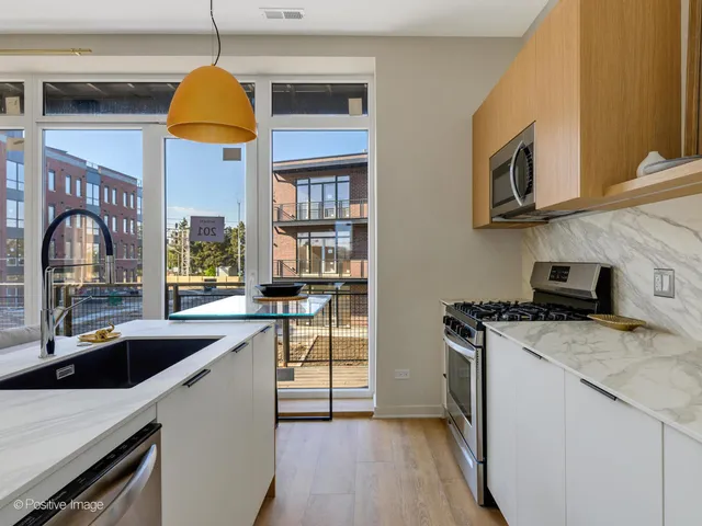a kitchen that has a sink and a stove