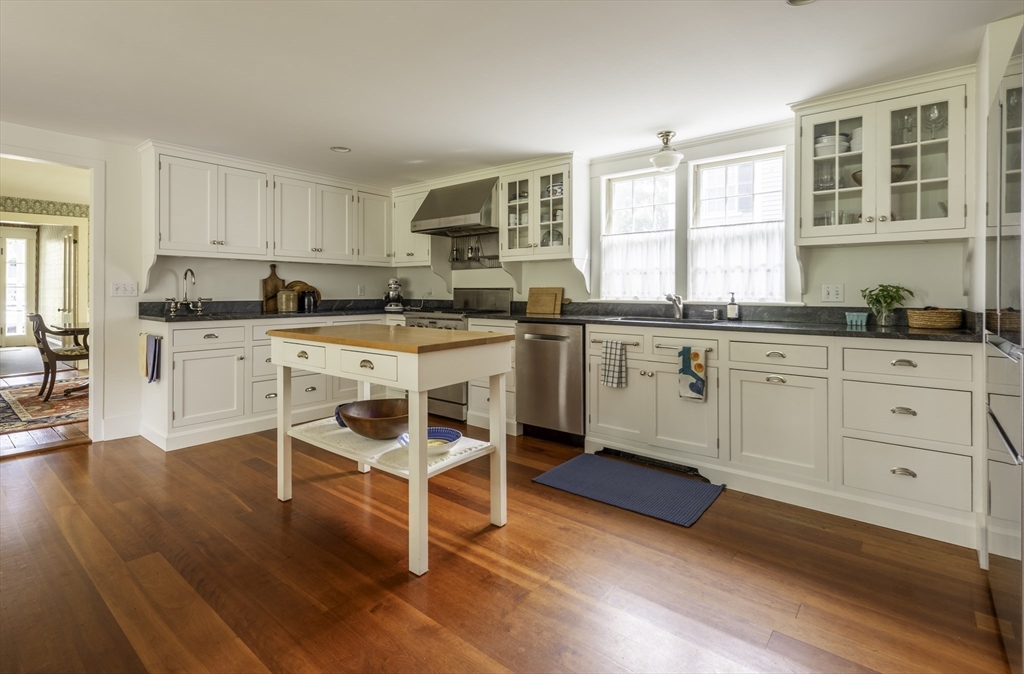 43 Middle Street Concord, MA 01742 - Photo 11 of 27 a kitchen with stainless steel appliances granite countertop a stove top oven a sink dishwasher and white cabinets with wooden floor