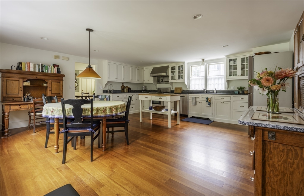 43 Middle Street Concord, MA 01742 - Photo 10 of 27 a view of a dining room and livingroom with furniture wooden floor a chandelier