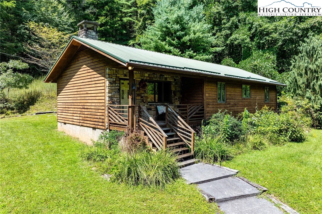 424 Poga Road Butler, TN 37640 - Photo 1 of 40 a backyard of a house with lots of green space