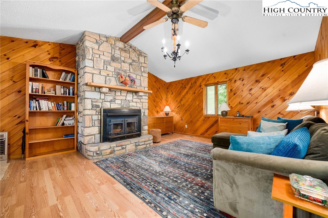 424 Poga Road Butler, TN 37640 - Photo 11 of 40 a living room with furniture a fireplace and a flat screen tv