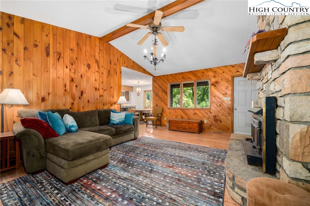 424 Poga Road Butler, TN 37640 - Photo 12 of 40 a living room with furniture a couch and a chandelier