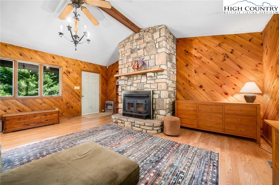 424 Poga Road Butler, TN 37640 - Photo 13 of 40 a bedroom with a bed and a fireplace