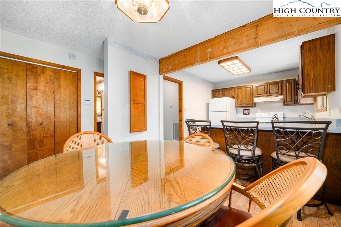 424 Poga Road Butler, TN 37640 - Photo 16 of 40 a dining room with furniture and wooden floor