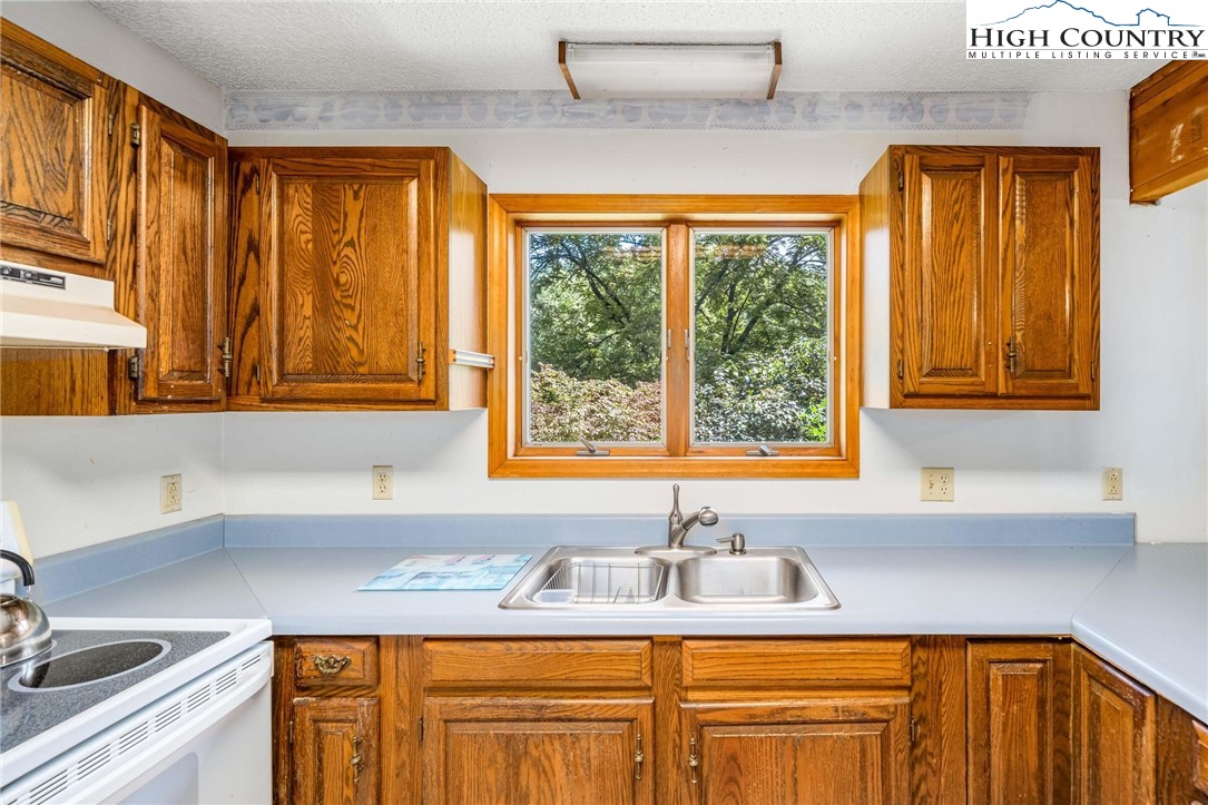 424 Poga Road Butler, TN 37640 - Photo 18 of 40 a kitchen with a window a sink and a cabinets