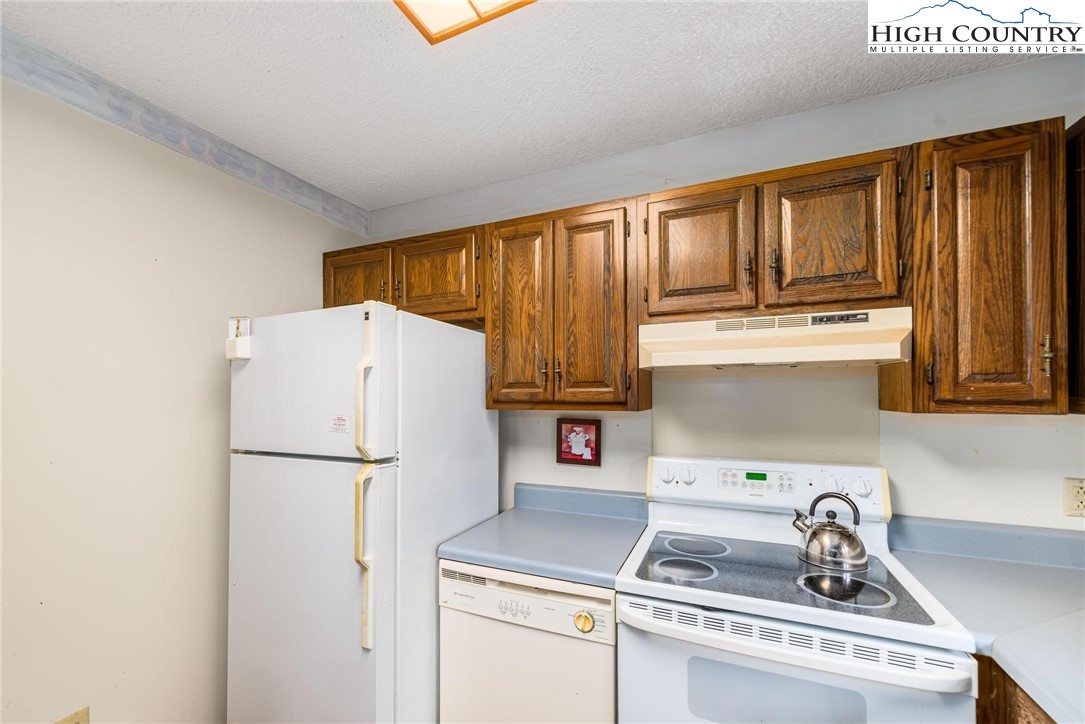 424 Poga Road Butler, TN 37640 - Photo 19 of 40 a kitchen with a refrigerator and a sink