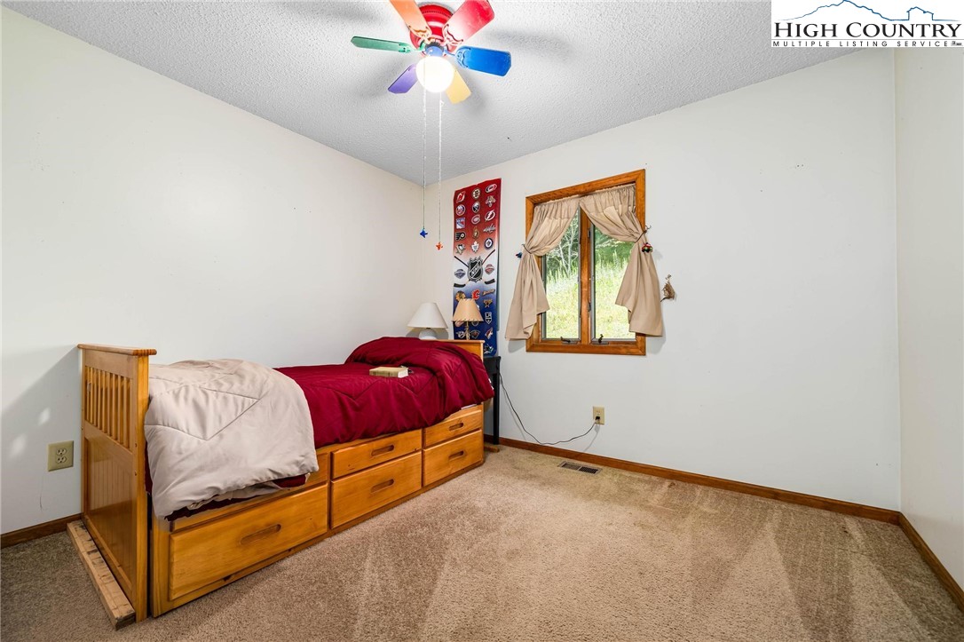 424 Poga Road Butler, TN 37640 - Photo 23 of 40 a bedroom with a bed and window