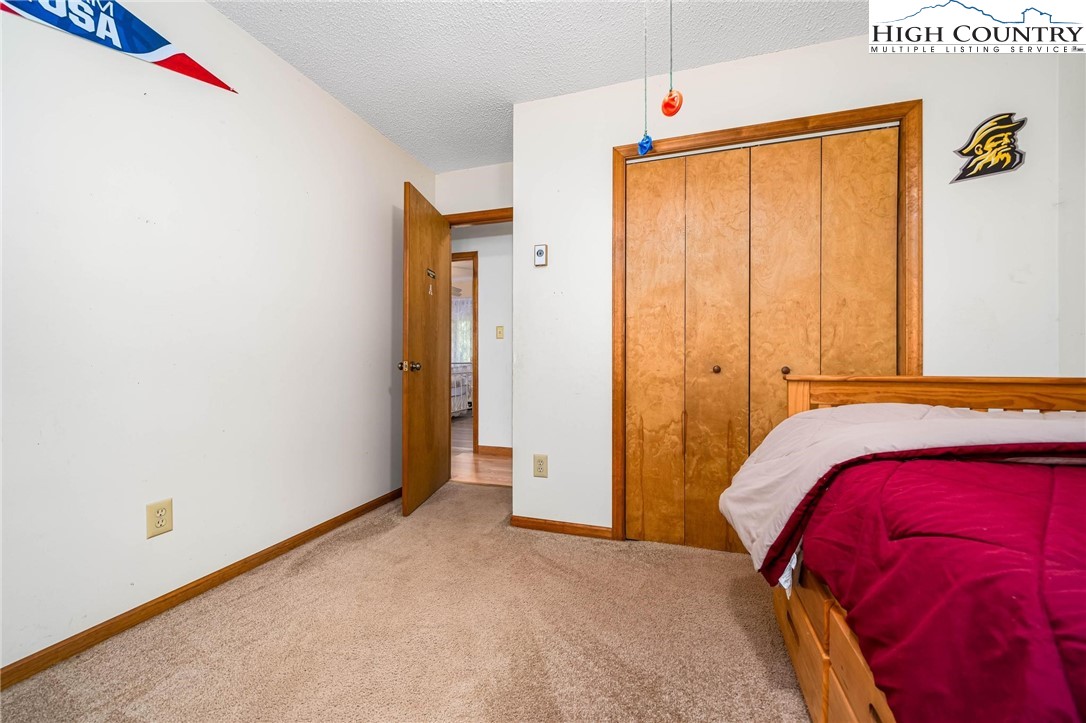 424 Poga Road Butler, TN 37640 - Photo 24 of 40 a bedroom with a bed and a window
