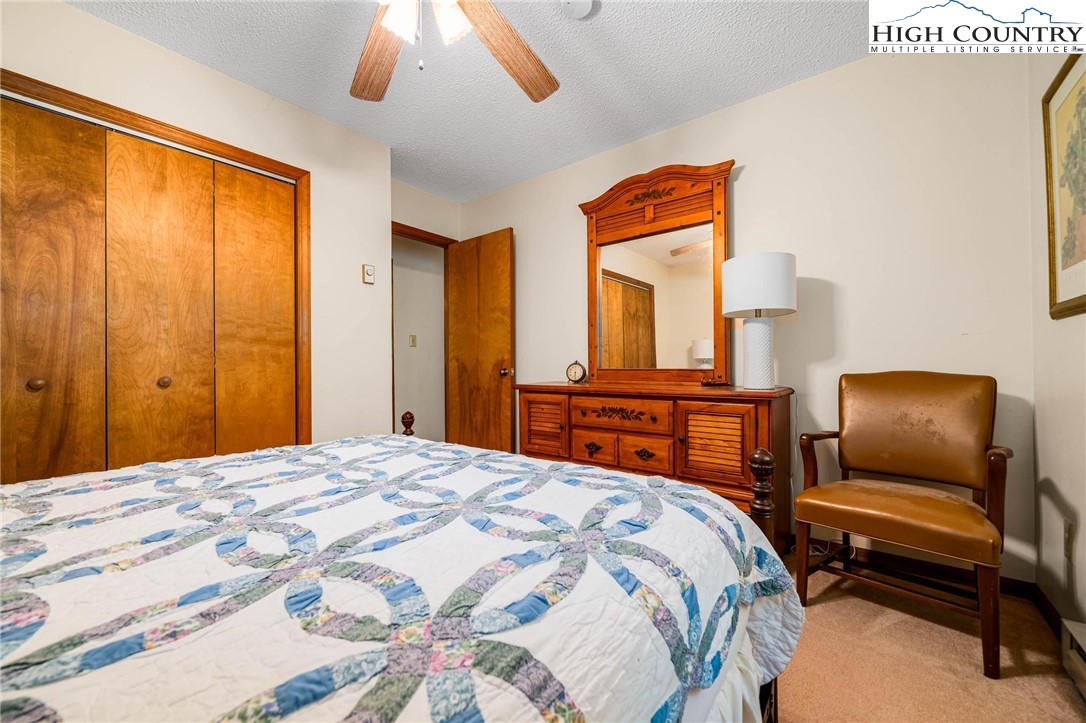 424 Poga Road Butler, TN 37640 - Photo 26 of 40 a bedroom with a bed and wooden floor