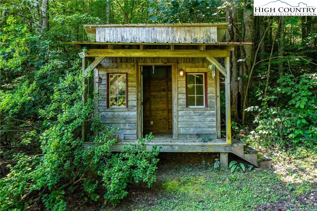 424 Poga Road Butler, TN 37640 - Photo 37 of 40 a view of a small house with large trees and plants